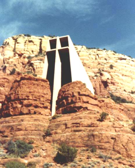 The Chapel of the Holy Cross towers above sandstone formations.